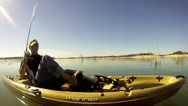 a man in a fishing pedal kayak