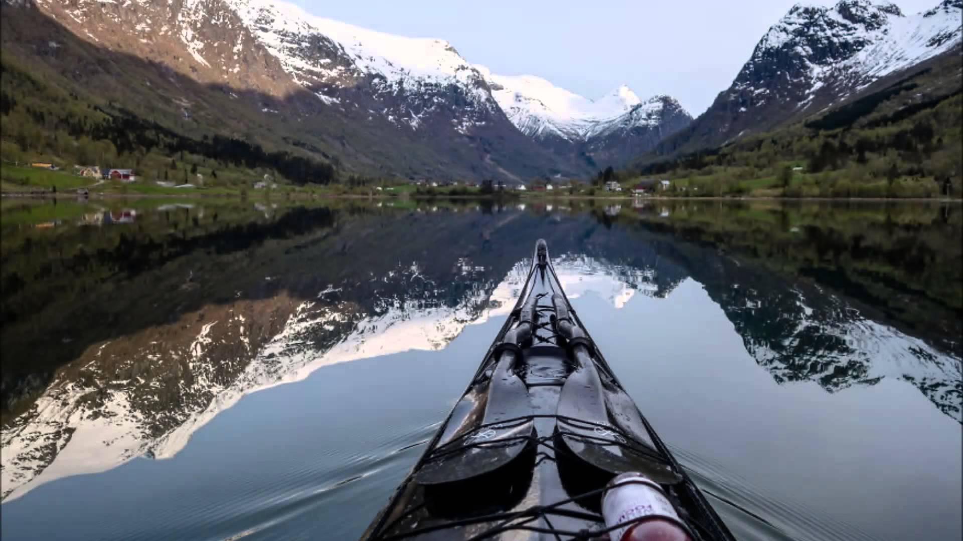 A kayak on a lake with mountains in the background.