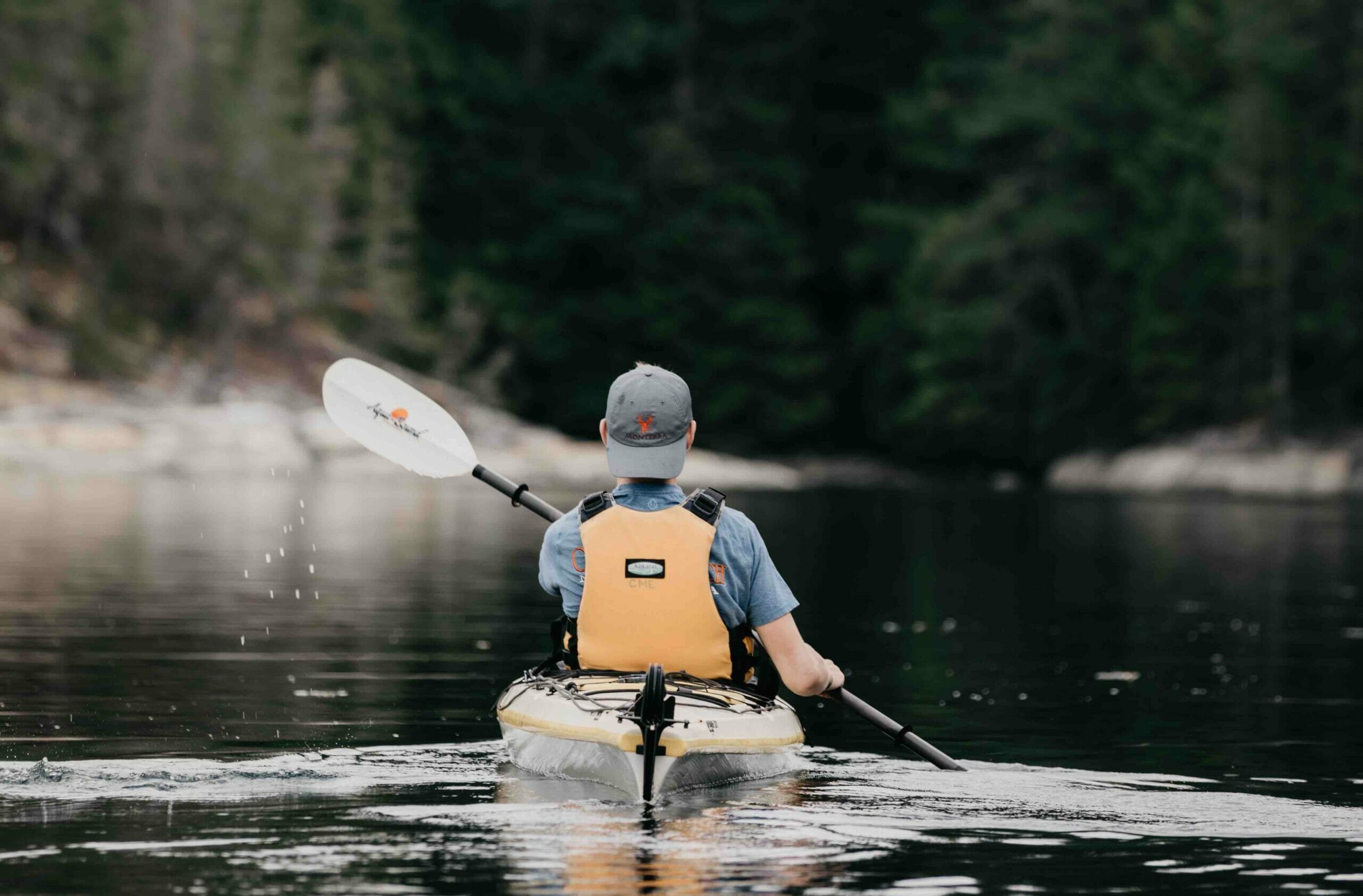 man kayaking in a lake