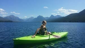 Woman on green Kayak on lake